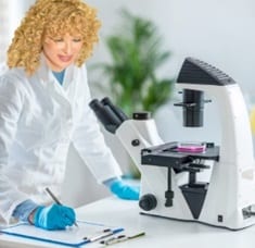 Epigenetics researcher in front of a microscope