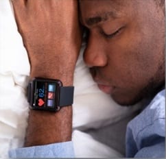 man sleeping with a smart watch