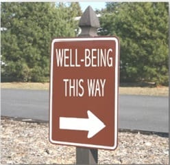 well-being this way sign on a road