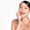 Beautiful young asian woman with clean fresh skin on white background