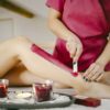 A beautician waxes a woman's leg in a salon - Beautiful female legs - Preparing bodies for the summer