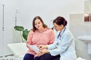Patient reviewing a medical weight loss plan with a doctor during a consultation.