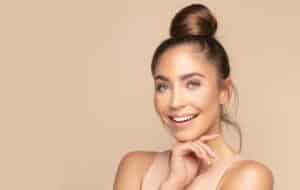Beautiful woman with voluminous cheeks enjoys the benefits of Belotero injections.