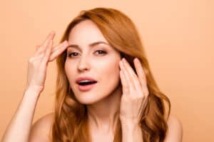 Woman excited by her smooth forehead after having a Dysport injection