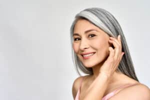 Gray-haired woman has flawless skin with regular microdermabrasion treatments.