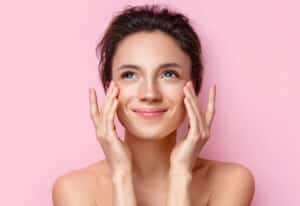 Woman with softly defined, tinted eyebrows and a natural makeup look.