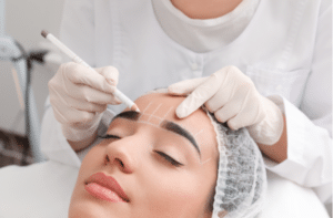 woman getting prepared for procedure of permanent eyebrow makeup