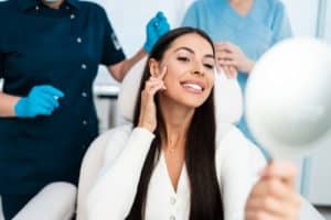 woman sitting in medical chair and looking in the mirror.